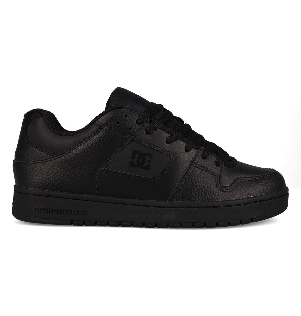 A black low-top Men’s Manteca 4 SE Shoe by DC Shoes, featuring a textured leather upper, black laces, and a flat rubber sole. This performance-focused skate shoe displays the iconic DC Shoes logo on the side panel and is presented in a right-facing profile view.