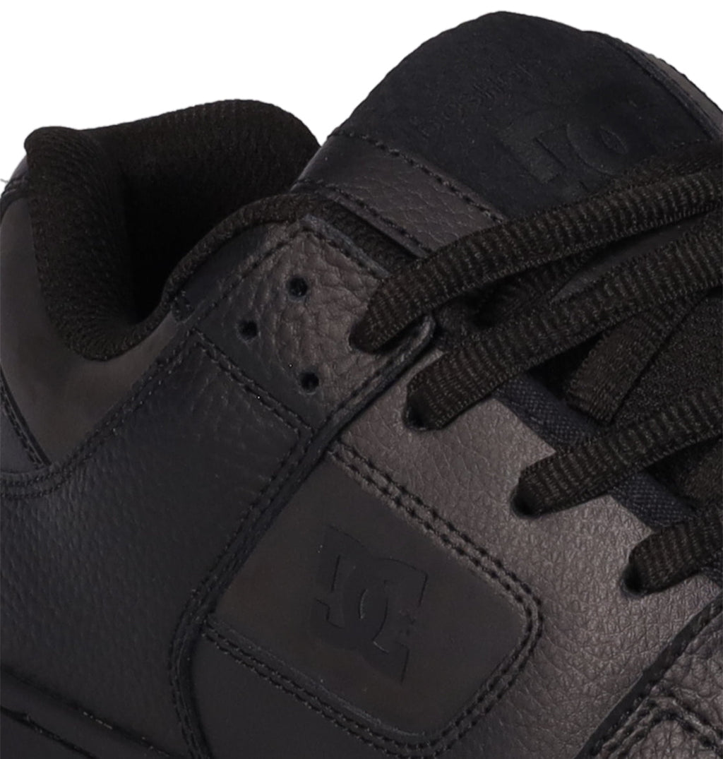 Close-up of the Men’s Manteca 4 SE Shoes in black, featuring black laces and textured leather for a performance-focused design. The DC Shoes logo is embossed on the side.