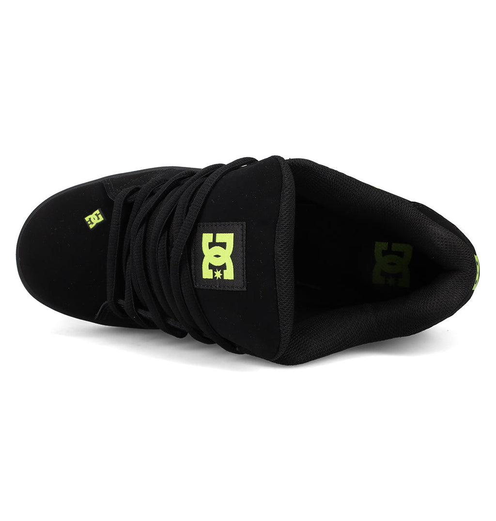 Top view of DC Shoes Men's Net Shoes, a puffy skate sneaker featuring black laces, durable fabric, and yellow-green DC branding on the tongue and inner heel.