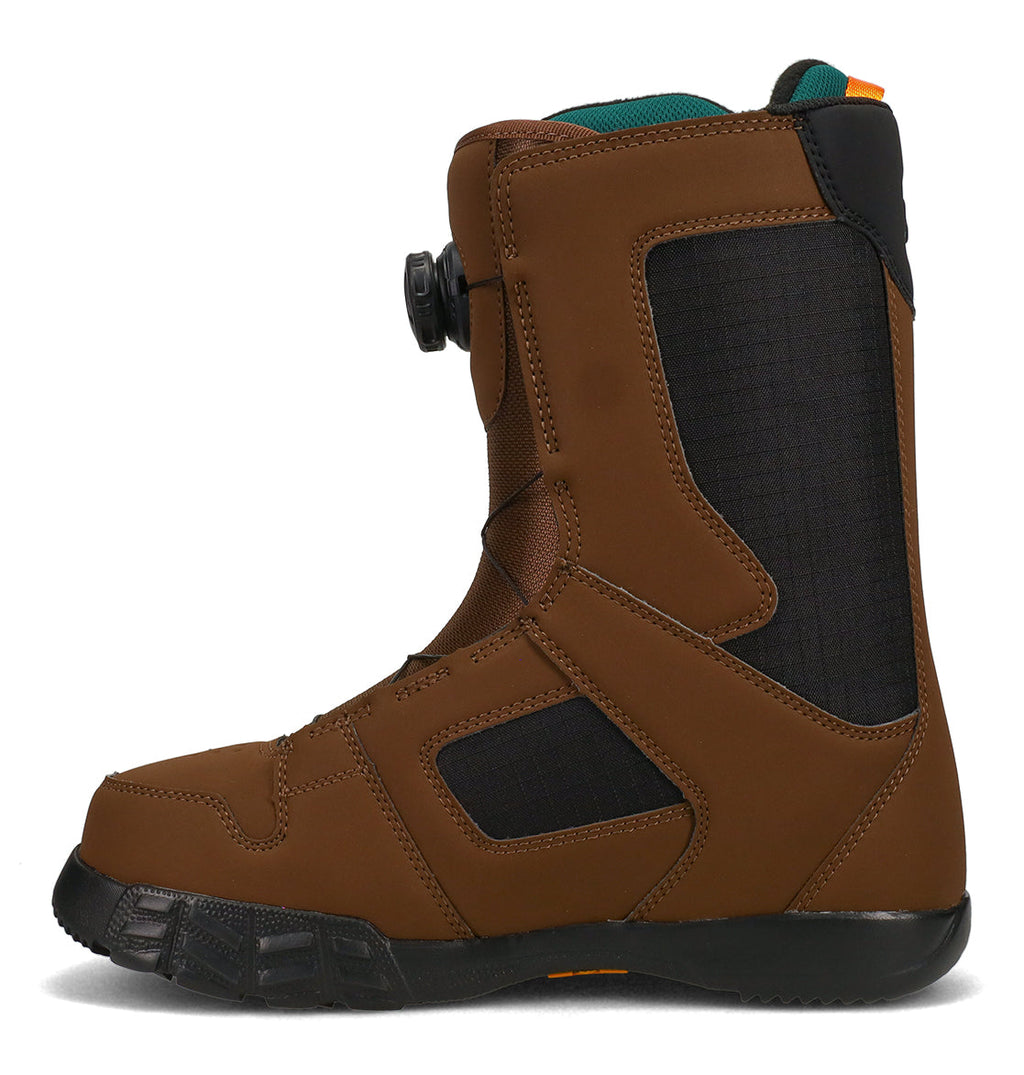 The DC Shoes Men’s Phase Boa Snowboard Boots feature a brown and black design, a textured rubber sole, and a side BOA lacing dial for a secure fit. Reinforced stitching enhances durability, while the boot’s sturdy build—viewed from the side—offers all-day comfort for winter sports.