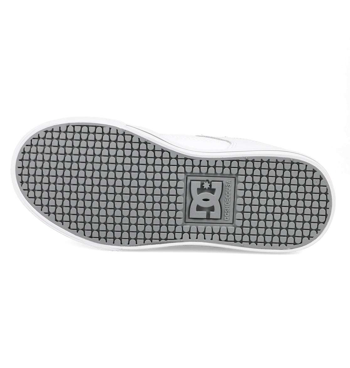 The image shows the sole of a white Kids’ Pure Shoe by DC Shoes, featuring a black patterned tread and the embossed DC logo near the center, highlighting its durable design.