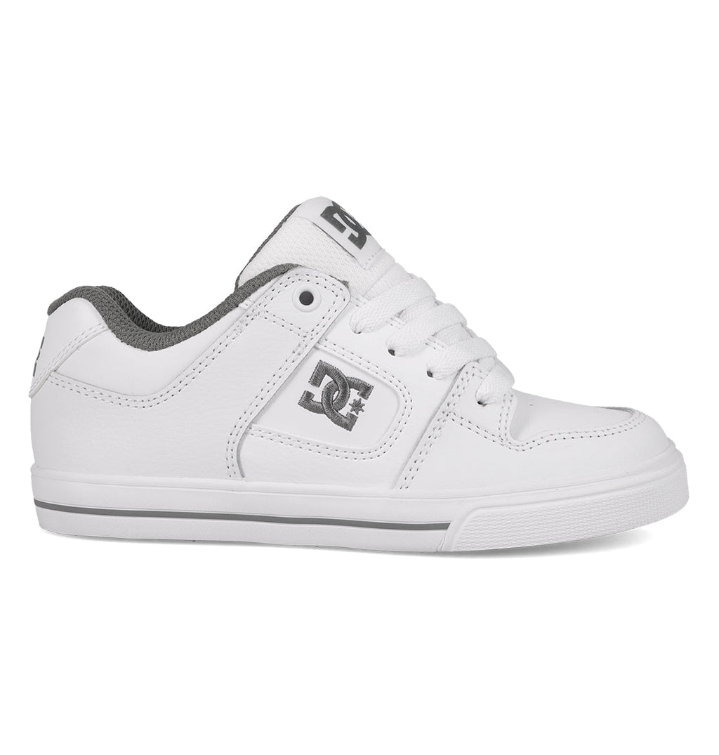 A comfortable and durable white Kids’ Pure Shoe by DC Shoes, featuring gray accents, a lace-up front, and a gray DC logo on the side and tongue, displayed in a left side profile view against a white background.