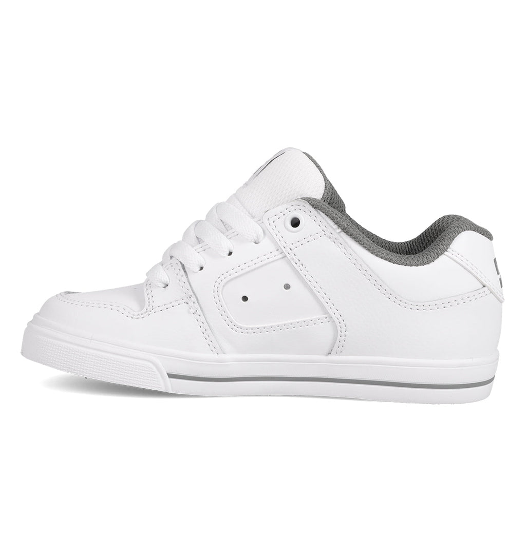 The Kids’ Pure Shoes by DC Shoes are comfortable and durable white low-top sneakers featuring white laces and a gray padded collar, displayed from the side against a white background.