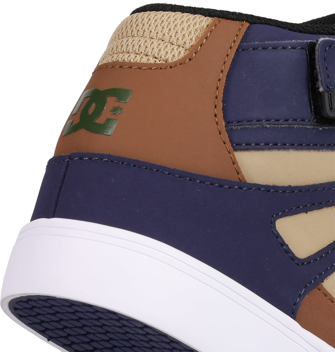 Close-up of the heel of DC Shoes Kids' Pure Hi Top EV, featuring tan, brown, and navy panels, a green DC logo, black mesh, and a white and purple rubber sole—ideal for young fans of stylish skate shoes.