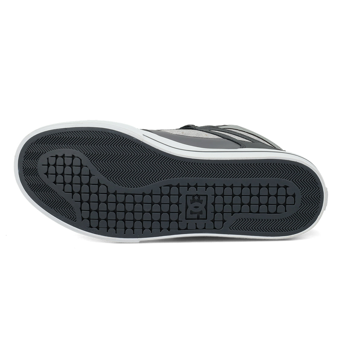 The image displays the black rubber sole of the Men’s Pure High Shoes by DC Shoes, featuring a textured pattern and a central logo, viewed from the bottom against a white background, emphasizing its comfortable and versatile design.