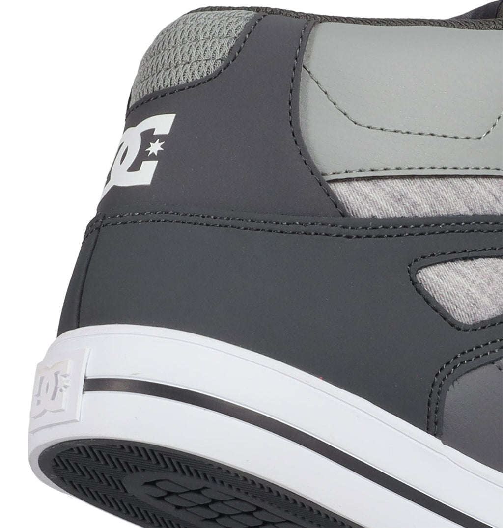 Close-up of the heel of a gray and white DC Shoes Men’s Pure High Shoe, displaying the DC logo on both the back and side. This versatile men’s sneaker features a textured gray upper paired with a white rubber sole, blending style and comfort for everyday wear.