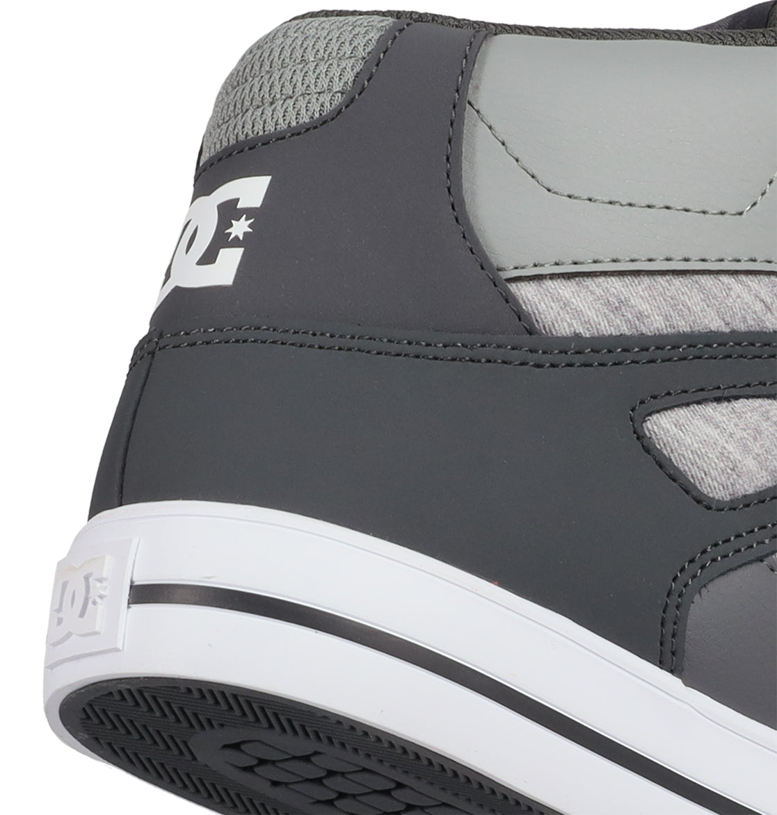 Close-up of the heel of a gray and white DC Shoes Men’s Pure High Shoe, displaying the DC logo on both the back and side. This versatile men’s sneaker features a textured gray upper paired with a white rubber sole, blending style and comfort for everyday wear.