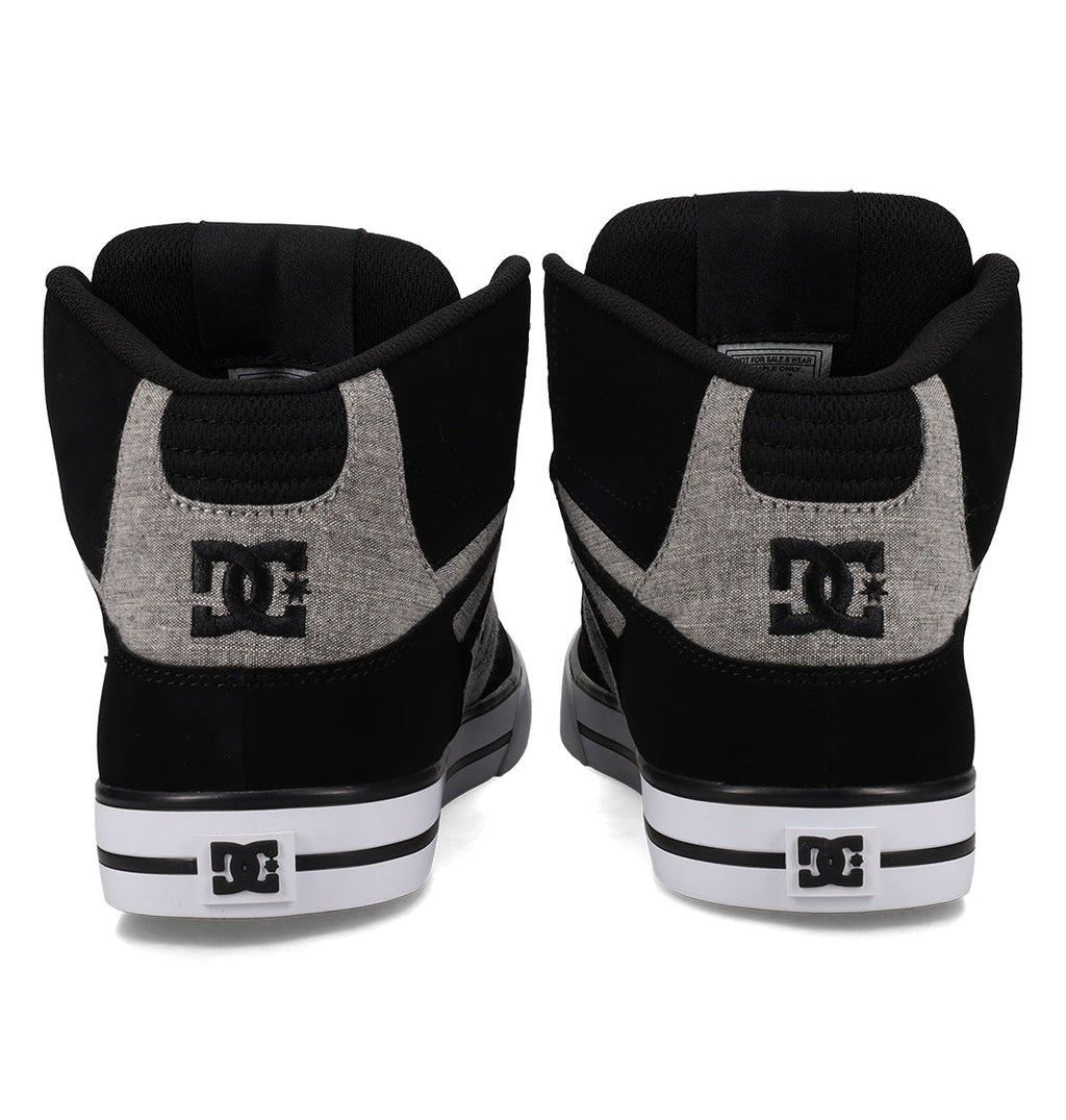 A pair of black and gray DC Shoes Men’s Pure High-Top Shoes is displayed from the back, showcasing the DC logo on the heels and back panels, complemented by white midsoles with black stripes. These durable sneakers are crafted to deliver both style and lasting comfort.