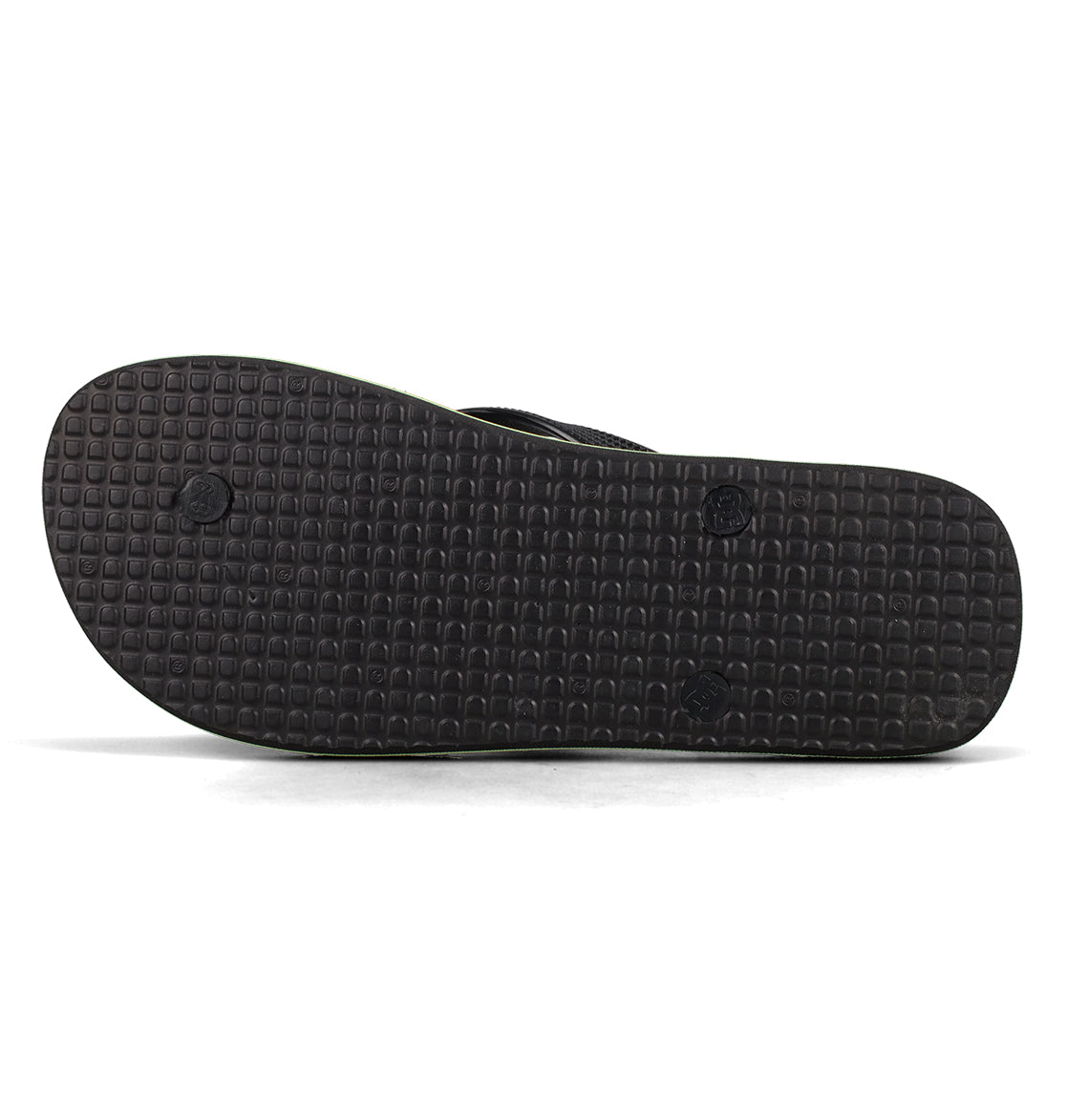 The image features the bottom view of DC Shoes Men’s Spray Slides in black, showcasing a textured, grid-like tread pattern that provides comfort and grip—making these must-have slides ideal for effortless slip-on wear whether you’re heading out or unwinding after a skate session.