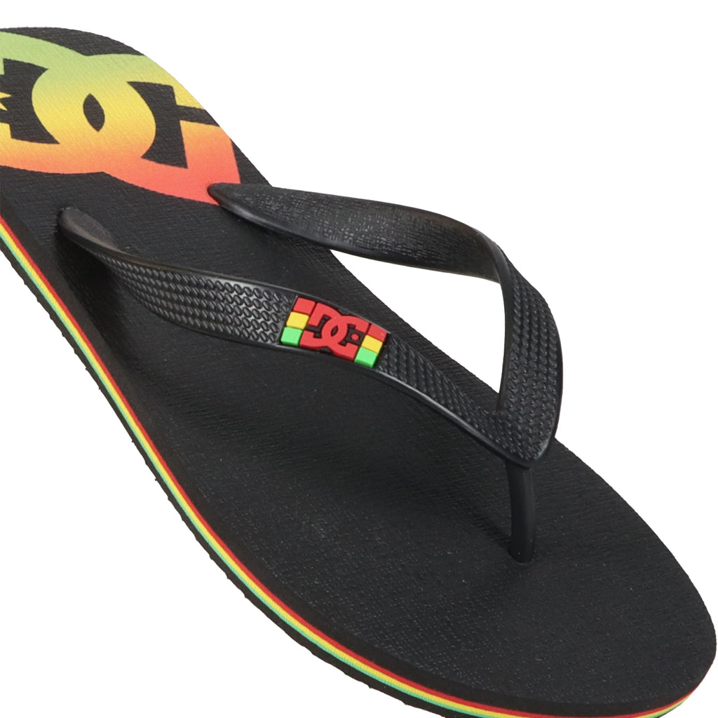 Step into comfort and style with the Men’s Spray Slides from DC Shoes—these black flip-flop sandals feature the iconic DC Shoes logo along with bold red, yellow, and green accents on the strap and sole, making them the perfect must-have slides to slip on before any skate session. Shown here against a white background.
