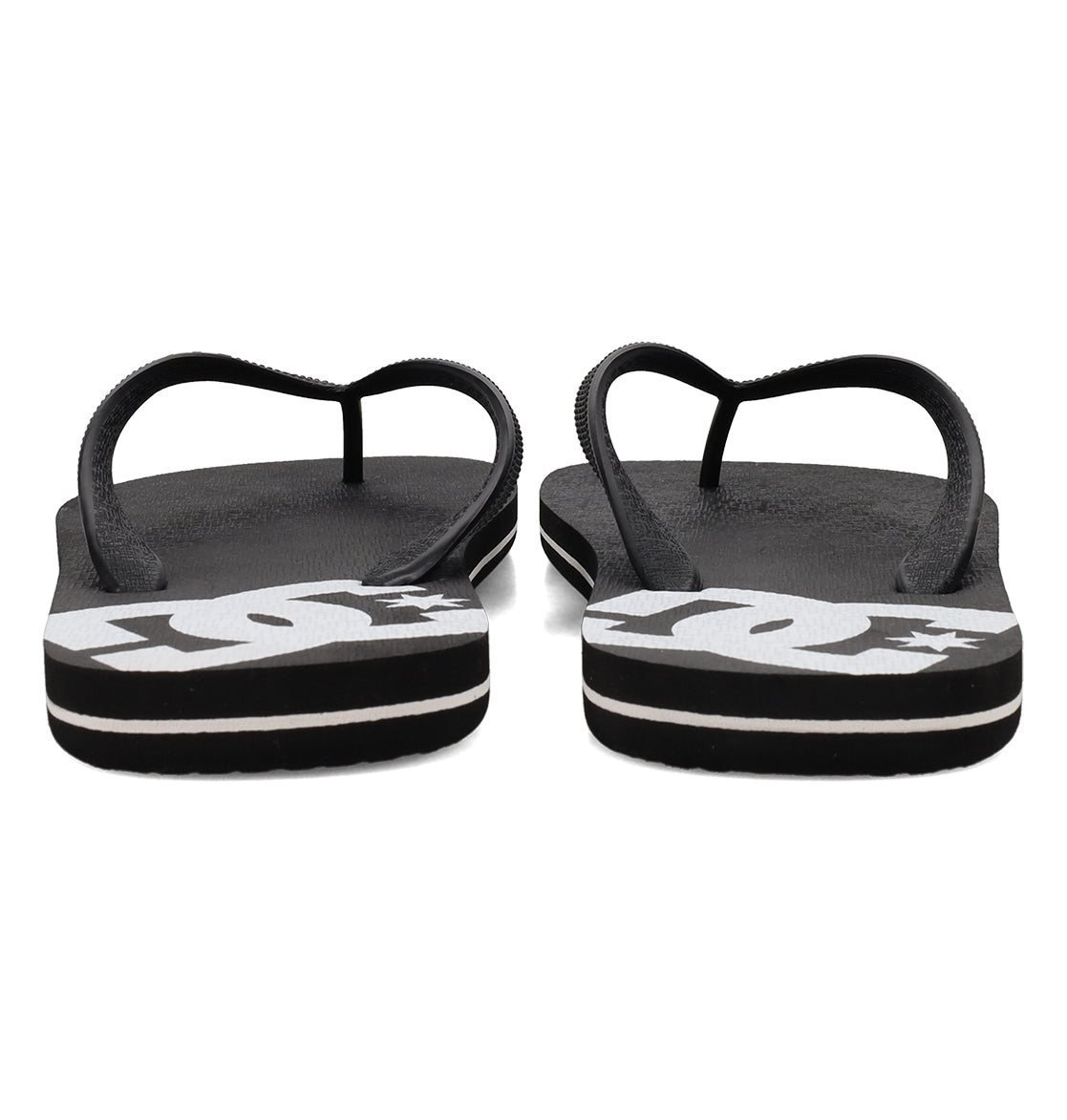 A pair of Men’s Spray Slides by DC Shoes, featuring black textured footbeds and thin straps, with bold white DC logos on the heels—these essential slides are ideal for slipping on after a skate session.