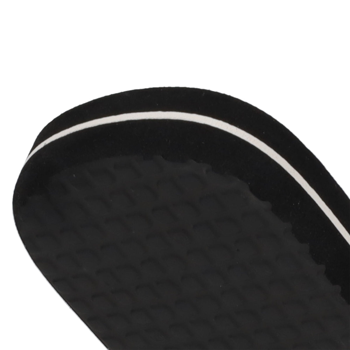 Close-up of the edge of a black Men’s Spray Slides sandal sole by DC Shoes, featuring a textured surface and a thin white stripe along the side, shown against a white background—these slides are an essential pick for comfort and style whether you’re relaxing after skating or heading out for the day.
