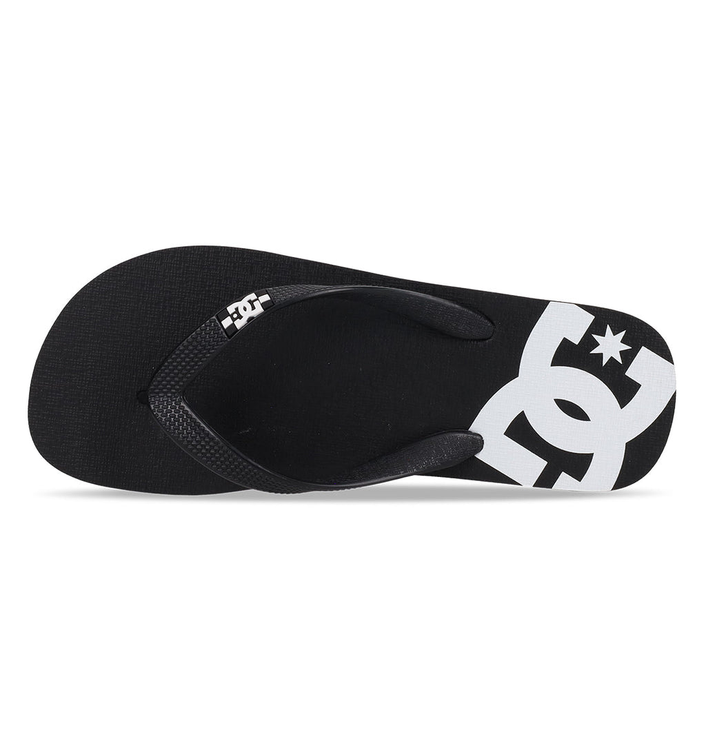 The DC Shoes Men’s Spray Slides feature a black flip-flop design with a white DC Shoes logo printed on the footbed, shown from above on a white background—these essential slides are ideal for slipping on after your next skate session.
