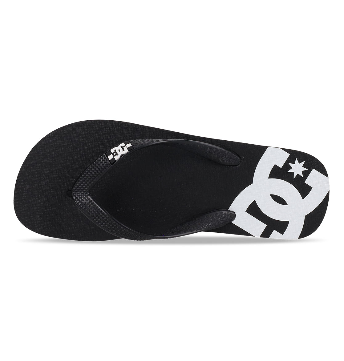 The DC Shoes Men’s Spray Slides feature a black flip-flop design with a white DC Shoes logo printed on the footbed, shown from above on a white background—these essential slides are ideal for slipping on after your next skate session.