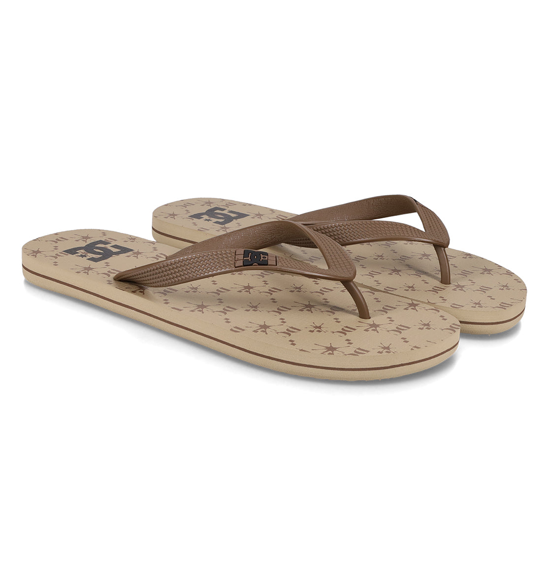 The Men's Spray Graffik Slides by DC Shoes feature beige soles with brown straps, a small star pattern, and the DC logo—perfect must-have slides for relaxing after a skate session.
