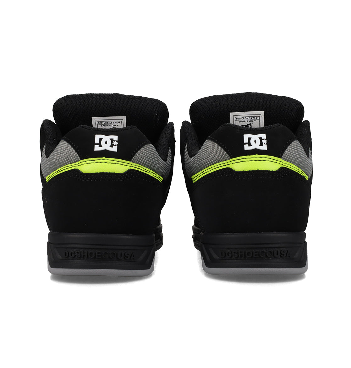 The Men's Stag Shoes by DC Shoes feature a black design with neon yellow accents, gray mesh details, and the white DC logo on the heels. Dynamic upper construction ensures both style and support for a standout look.