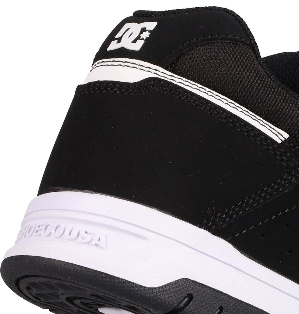 Close-up of the heel of the Men's Stag Shoes by DC Shoes, showcasing skate culture heritage with the DC logo and embossed SHOESCOUSA text on the cupsole.