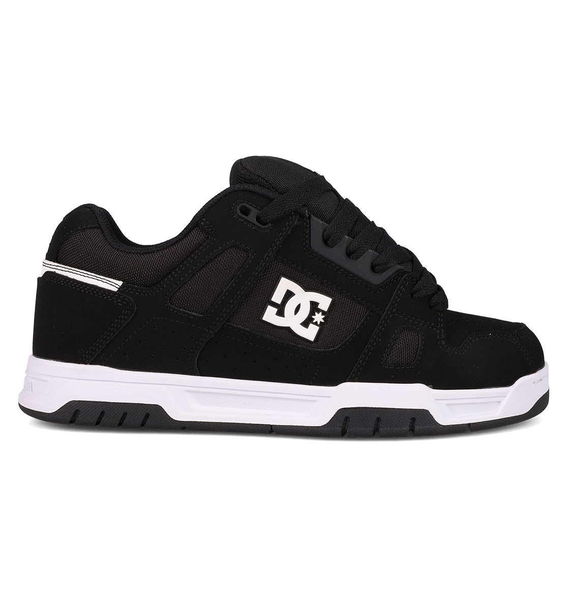 The Men's Stag Shoes by DC Shoes are shown in side profile against a white background, featuring a black upper with a white side logo, black laces, and a thick white and black cupsole—ideal for skate culture enthusiasts.