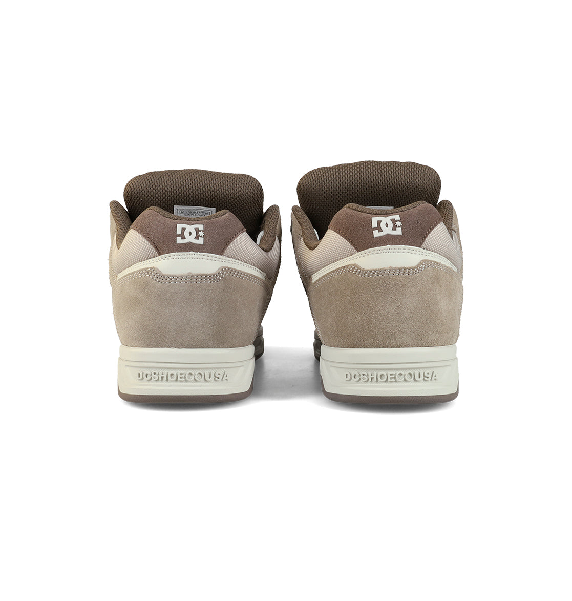 The Men's Stag Shoes by DC Shoes are shown from the back in brown and beige, featuring suede and mesh uppers, a durable cupsole, DC branding on heel and tongue, oversized puff accents, and padded collars.