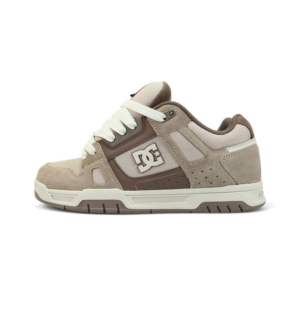 The Men's Stag Shoes by DC Shoes feature a beige and brown suede and mesh design with white laces, a white sole, the DC logo on the side, a durable cupsole, oversized puff tongue, and chunky style for comfort and flair.