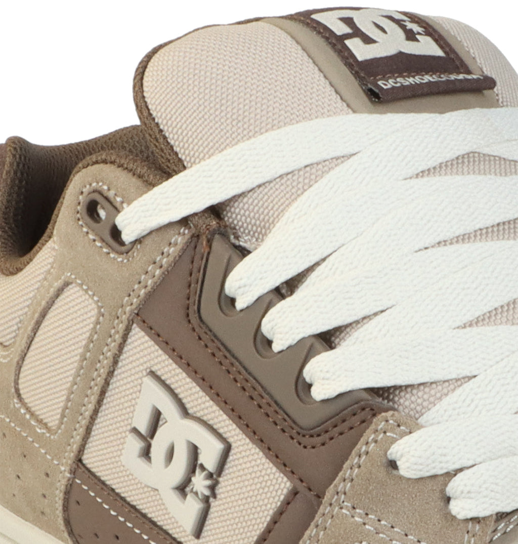 Close-up of a beige and brown Men’s Stag Shoe by DC Shoes with white laces, featuring an oversized puff design and the signature DC logo on the side and tongue. The durable cupsole provides long-lasting wear, making these DC Shoes both stylish and dependable.