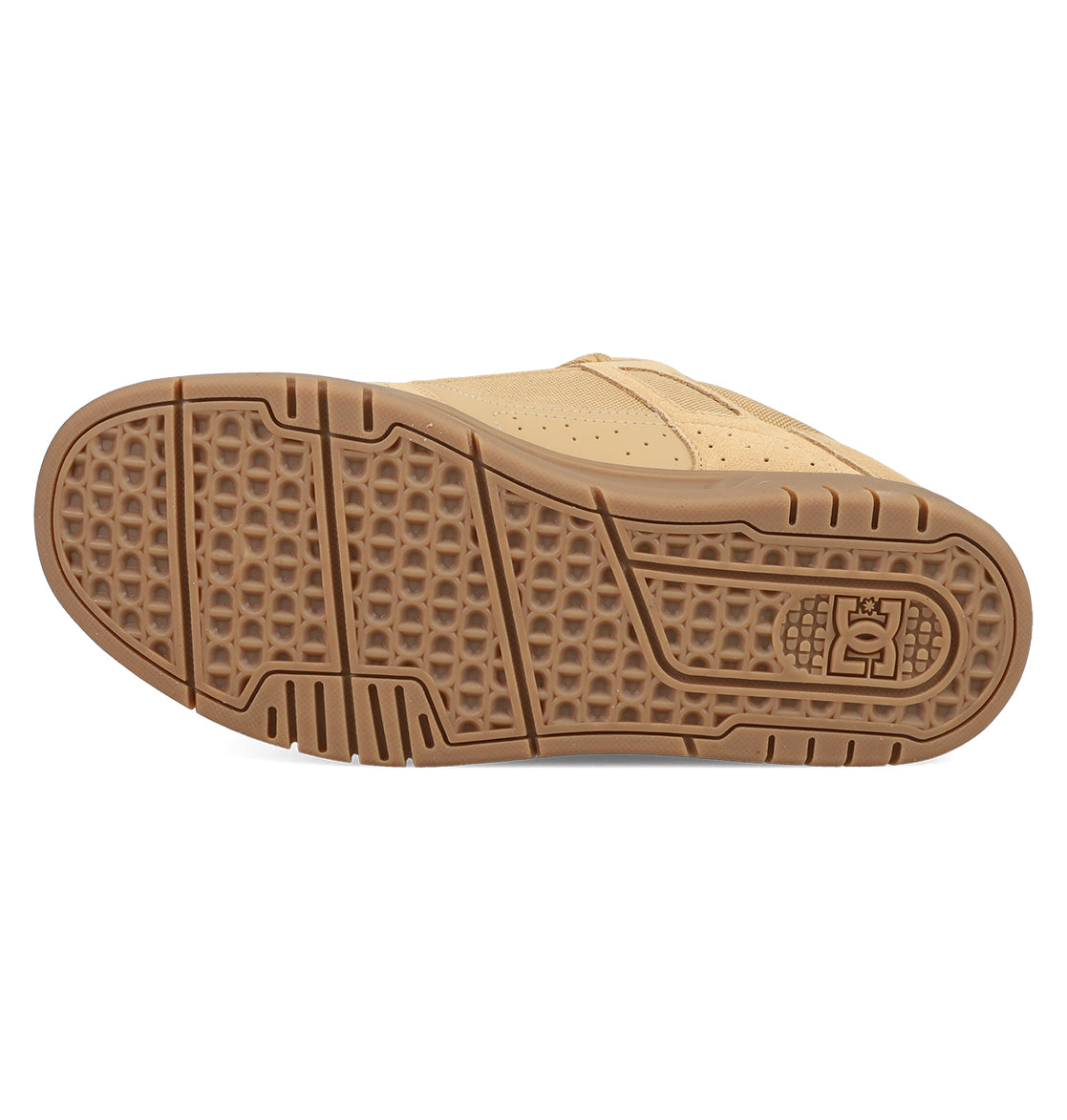 The image shows the sole of the DC Shoes Men's Stag Shoes in tan, featuring a textured brown rubber outsole with geometric patterns, cupsole construction, and the DC logo near the heel—highlighting classic skate-inspired design.