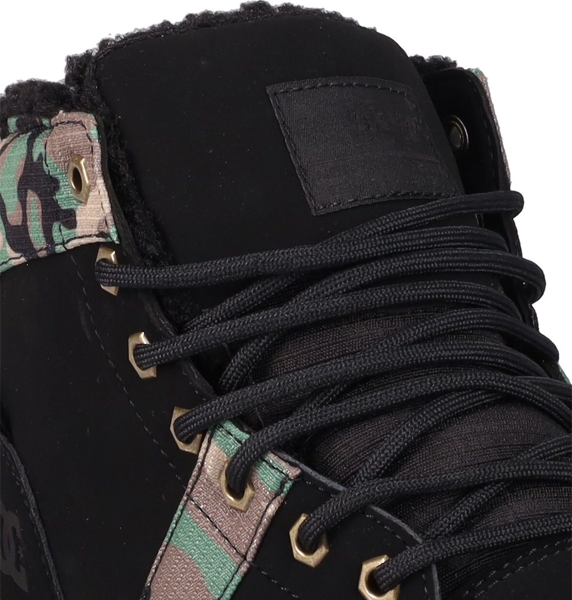 Close-up of the Men's Woodland Winter Boots by DC Shoes: black sneaker with camouflage accents, black laces, gold eyelets, textured tongue, and sherpa lining inspired by classic men’s winter boots.
