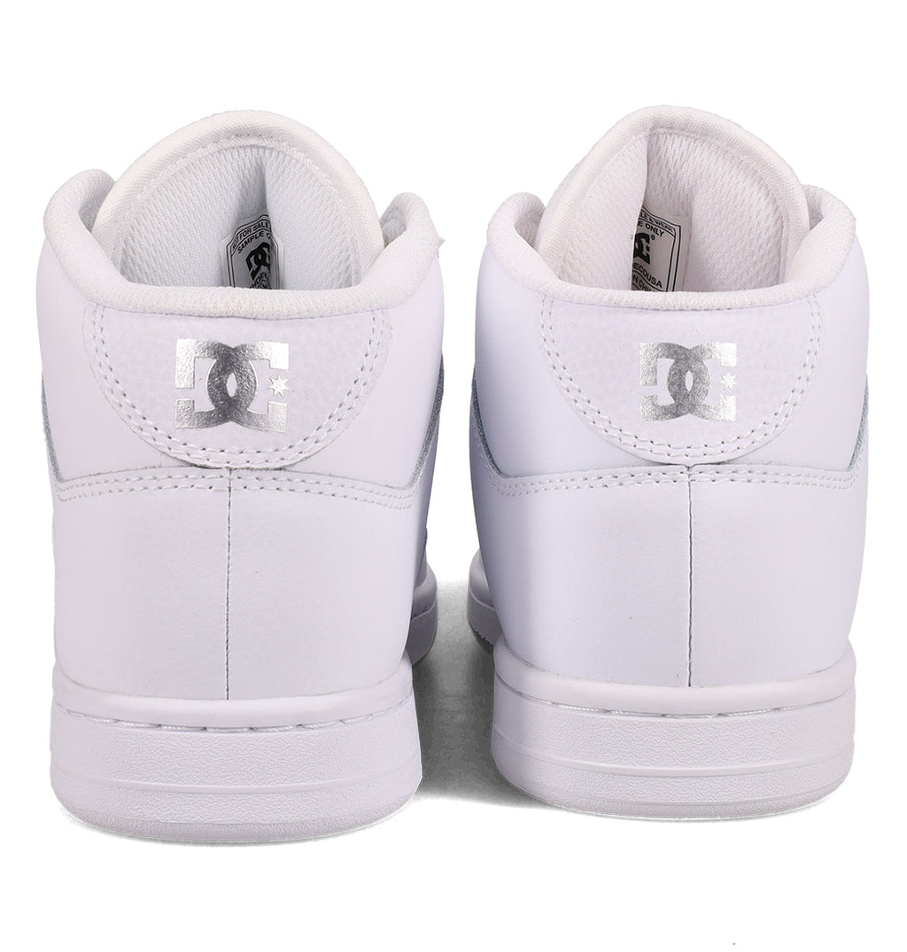A pair of white DC Shoes Women’s Manteca 4 Hi High-Top Shoes is shown from the back, with the silver DC logo visible on the heel tabs. The shoes are positioned side by side against a plain white background.