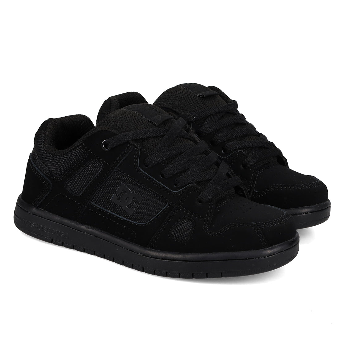 A pair of Kids’ Stag Shoes by DC Shoes in black, featuring laces, mesh panels, and textured cupsoles inspired by the brand’s iconic design, displayed side by side on a white background.
