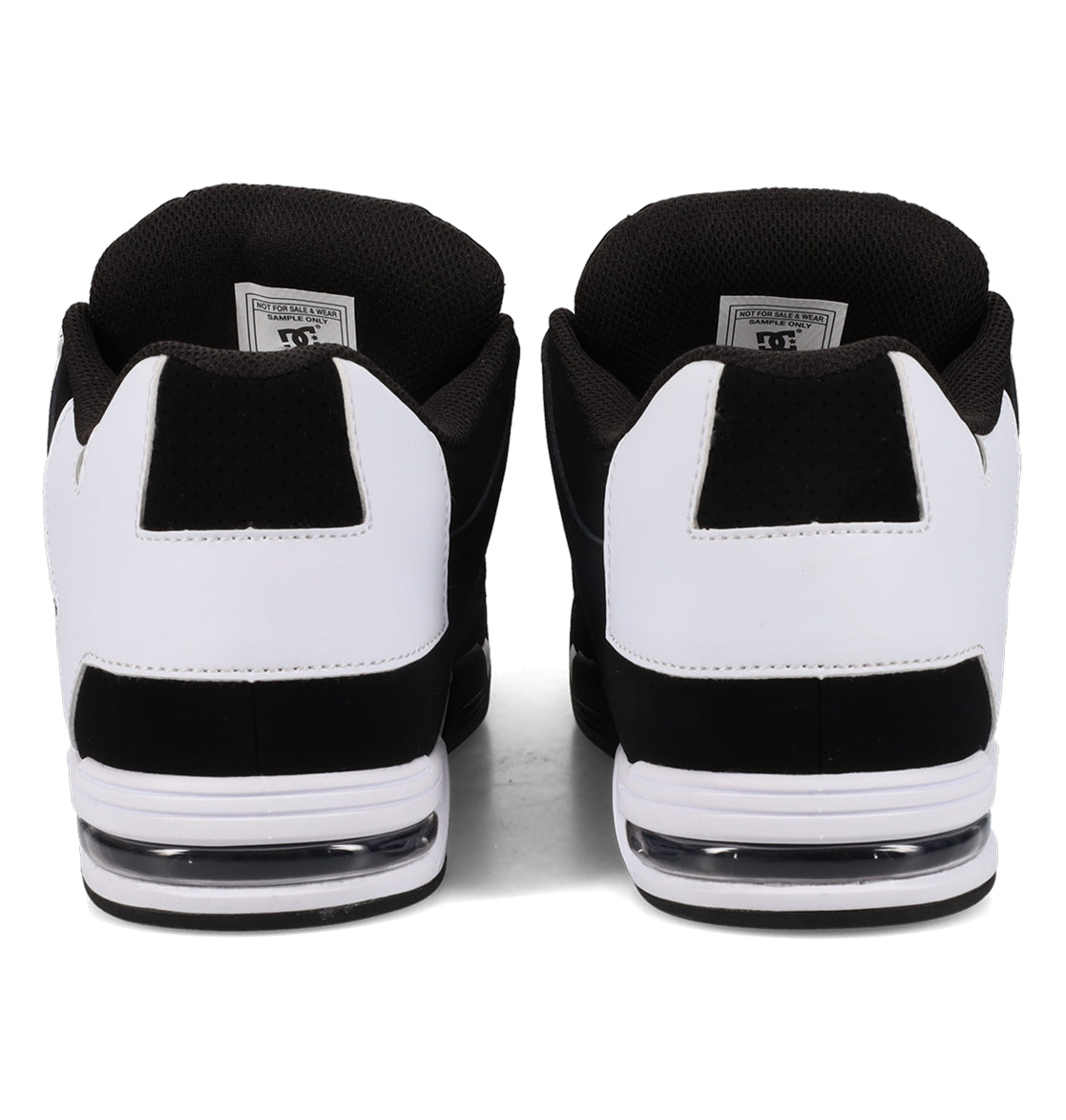 A pair of Men’s Command Shoes by DC Shoes in black and white, shown from the back, feature signature heel cushioning, visible air soles, a textured black interior, and classic DC bulk highlighted with white accents.