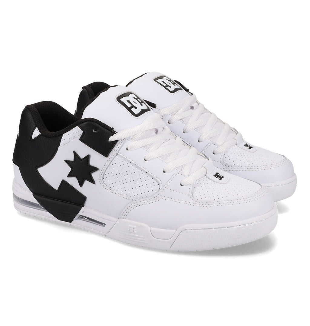 A pair of DC Shoes Men’s Command skate shoes in white and black, featuring perforated sides, signature DC bulk, a black star-shaped DC logo, white laces, and black accents on the heel and tongue for lasting comfort.