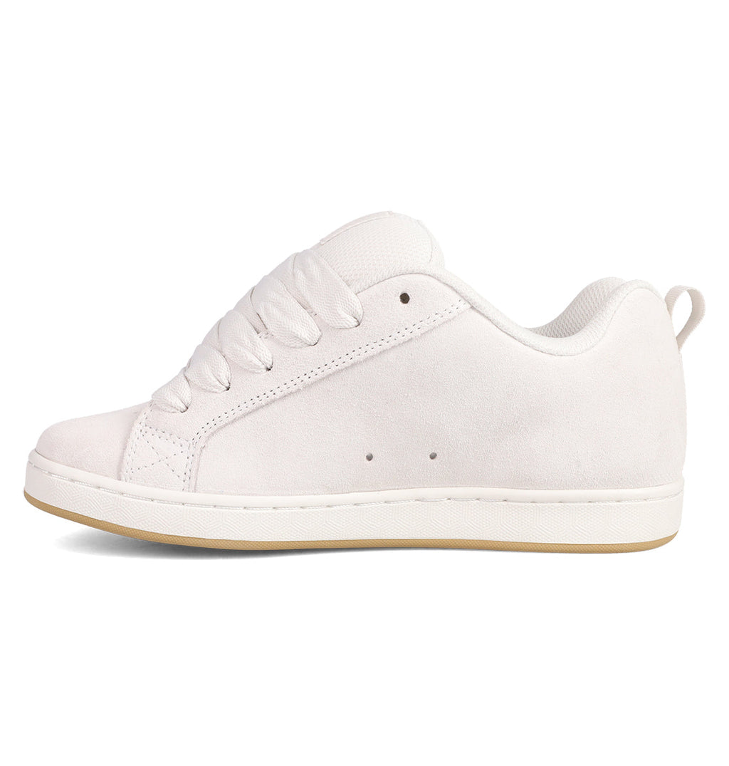 The Women's Court Graffik SD Shoes by DC Shoes feature a white suede upper, thick laces, and a light tan rubber sole with a puffy silhouette, shown in side profile against a white background.