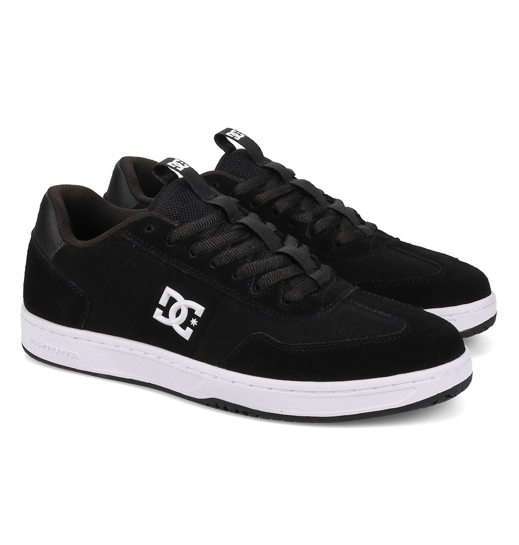 A pair of Men’s Astrix Shoes by DC Shoes in black, featuring white soles and the signature DC logo on the side, designed for optimal board control. The shoes are positioned side by side, facing slightly to the right.