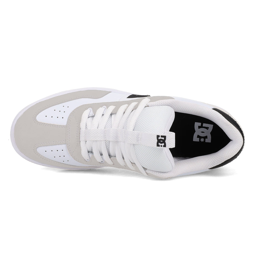 Top view of the Men’s Astrix Shoes by DC Shoes in white and gray, featuring white laces, a mesh tongue, and the DC logo on both the tongue and inside heel area. Designed for street skateboarding, these shoes offer perforations on the toe box for ventilation and improved board control.