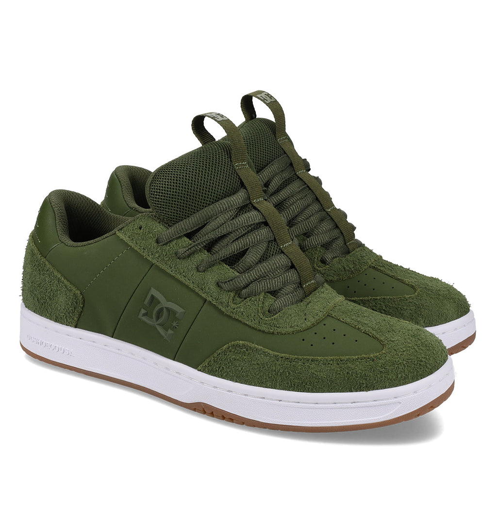 A pair of DC Shoes Men’s Astrix Shoes in green, featuring textured suede accents, thick green laces, white rubber soles, and gum outsoles—designed for street skateboarding and improved board control—displayed on a white background.