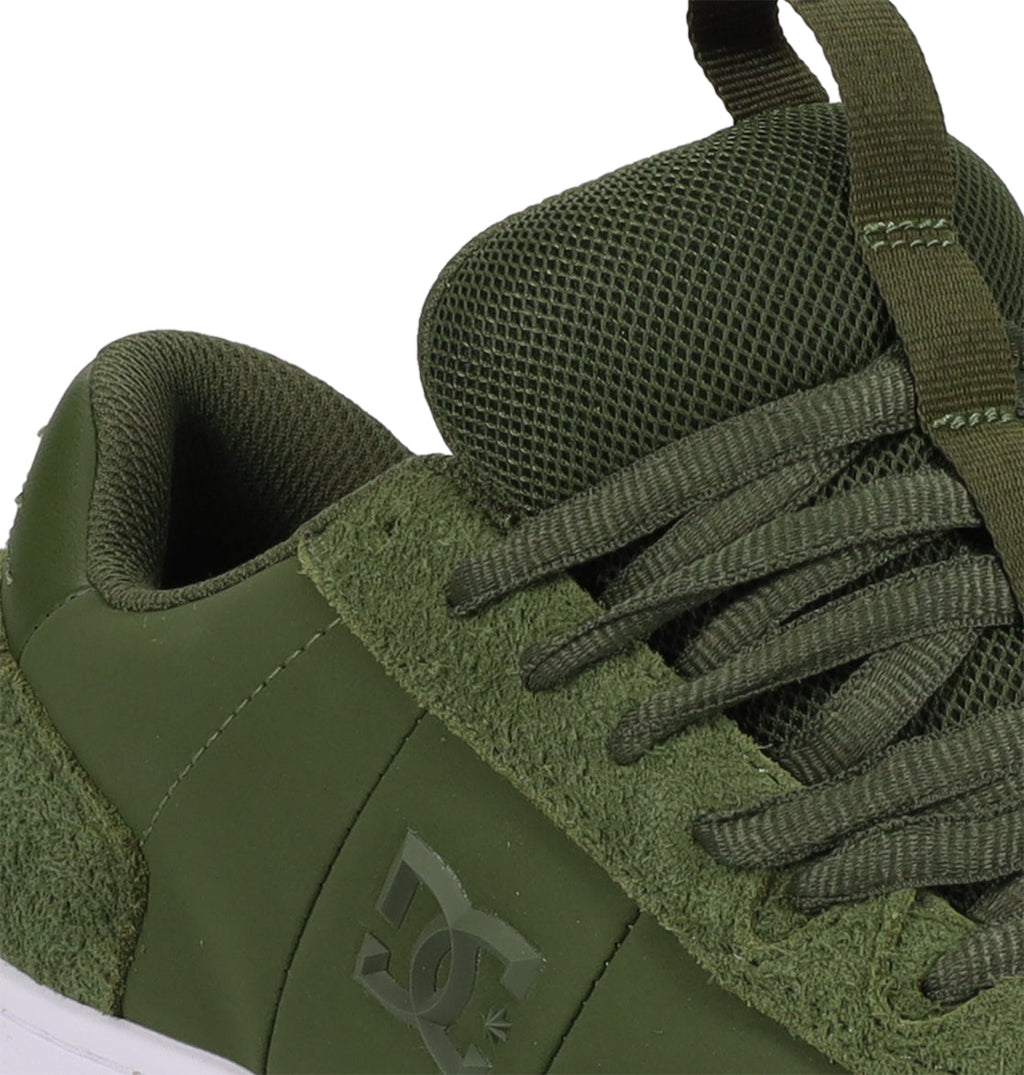 Close-up of the DC Shoes Men’s Astrix Shoes in olive green, featuring a combination of suede and mesh textures, thick laces, and the DC Shoes logo embossed on the side—engineered for street skateboarding to provide enhanced board control.