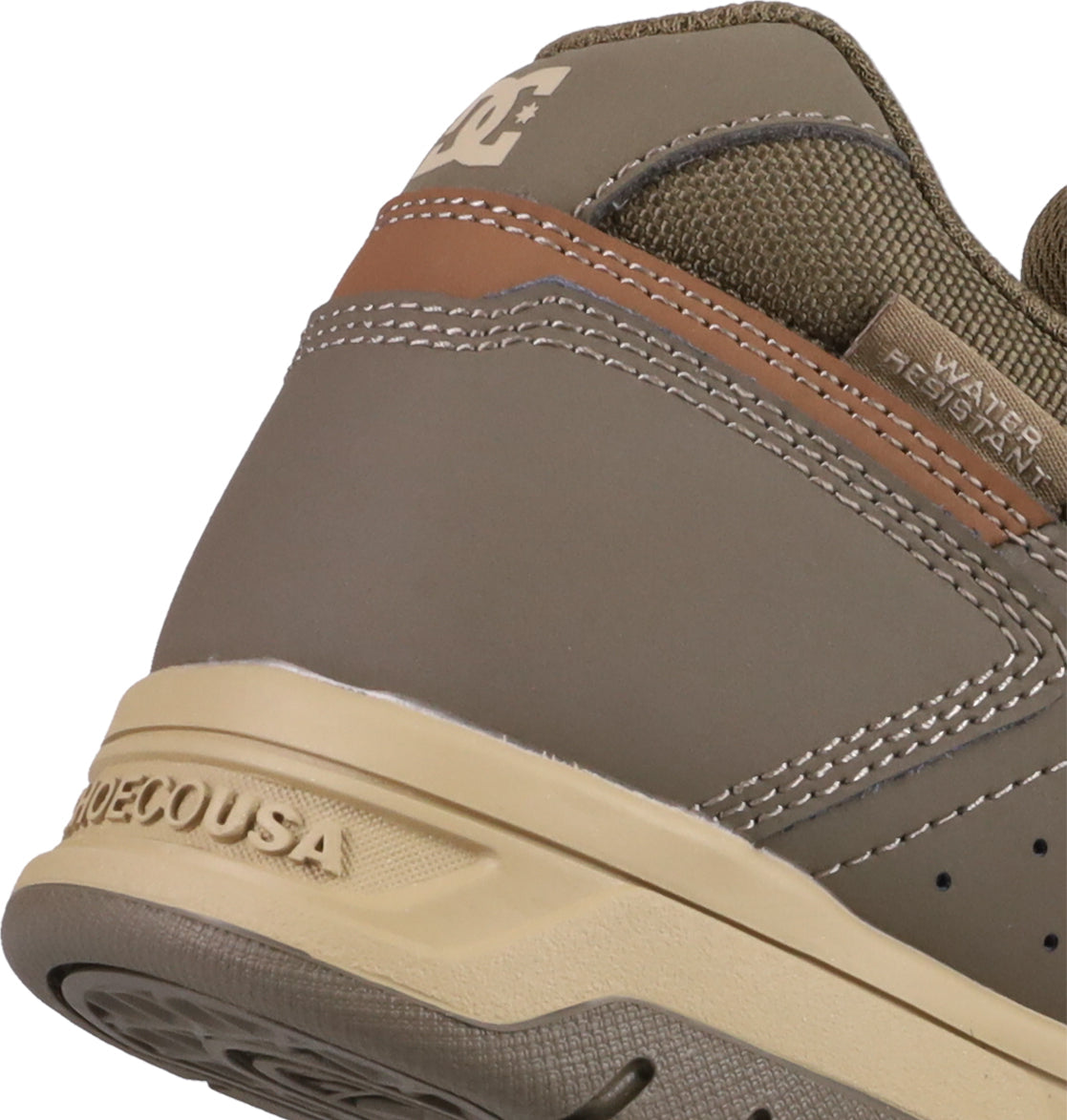 Close-up of the heel on Men's Stag Shoes by DC Shoes in brown and tan, featuring the “DC” logo, “WATER RESISTANT” text, textured stitching, and a sturdy cupsole inspired by skate culture.