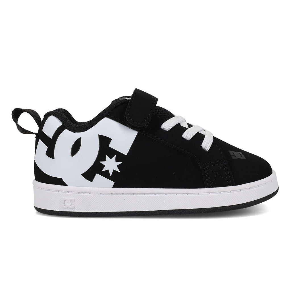 The Kids’ Court Graffik Shoes - Toddler by DC Shoes feature a puffy black upper with a large white DC logo on the side, complemented by white laces, a velcro strap, and a white sole. Inspired by the iconic Court Graffik style, these black and white sneakers are pictured in a side profile view.
