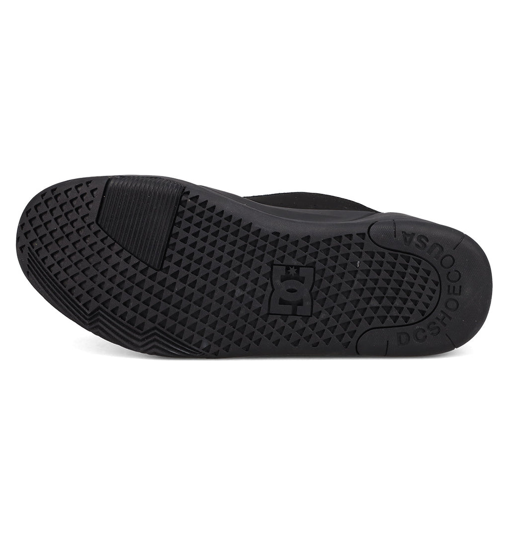 The image shows the black rubber sole of DC Shoes Men's Fractal Shoes, with a geometric fractal-inspired grip pattern, the DC Shoes logo at the center, and "DC SHOES" and "USA" embossed near the heel.