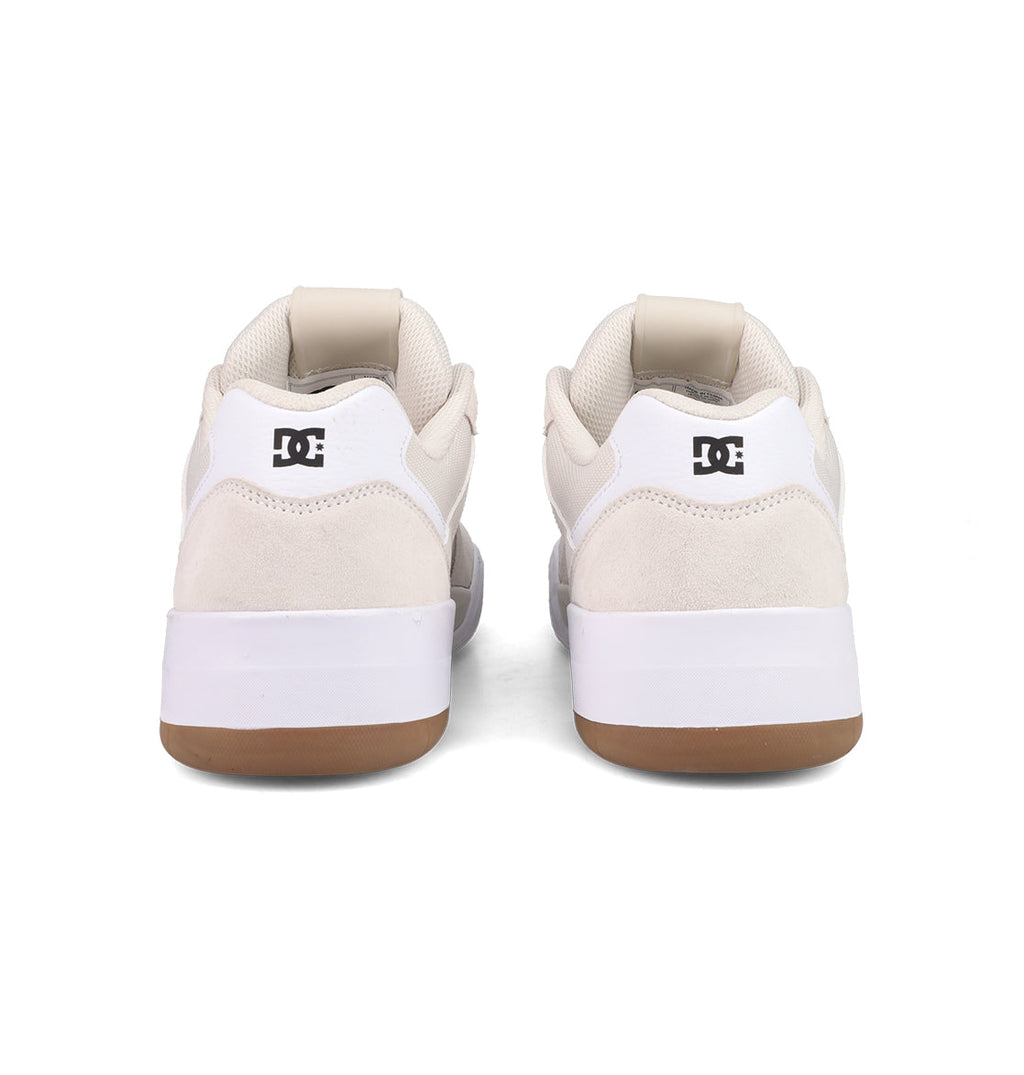A pair of Men's Fractal Shoes by DC Shoes shown from the back, featuring white uppers, beige suede accents, white midsoles, gum rubber outsoles, and black DC logos on the heels for a street-ready look.