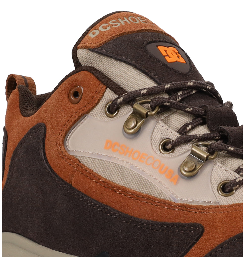 Close-up of the Men’s Recon OG Shoes by DC Shoes in brown and orange, showcasing the logo on both the tongue and side, metal eyelets, and two-tone laces against a plain white background—emphasizing their durable construction designed for all-weather wear.