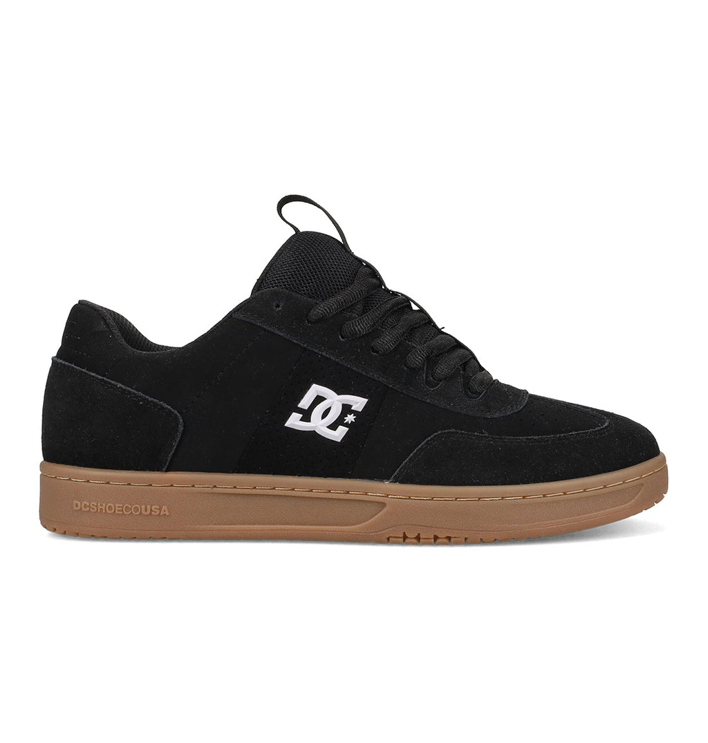 The Men's Astrix Shoes by DC Shoes are black skate shoes for street skating, featuring black laces, a white DC logo on the side, and a flat brown rubber sole for excellent board control.