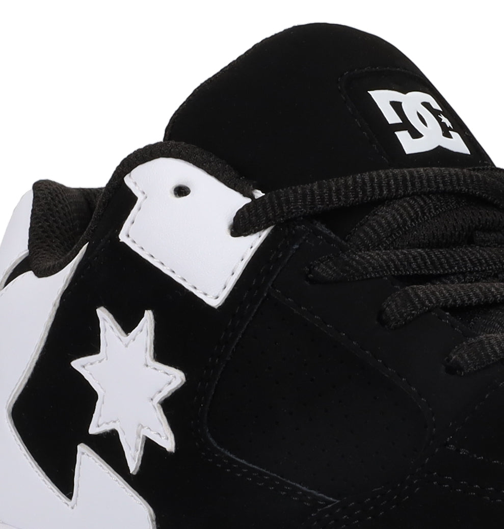 Close-up of the Women’s Command Shoe by DC Shoes in black and white, featuring the DC logo on the tongue and a distinctive star and lightning bolt motif on the side. Signature cushioning ensures comfort with every step, while its old-school energy makes this sneaker stand out.