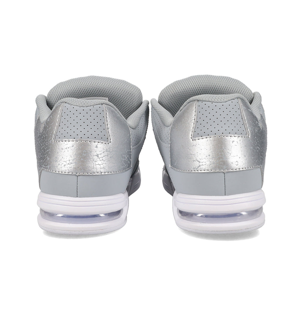 Back view of the DC Shoes Women’s Command Shoes in gray and silver, showcasing perforated heels and visible air-cushion soles, combining retro style with signature cushioning for enhanced comfort.
