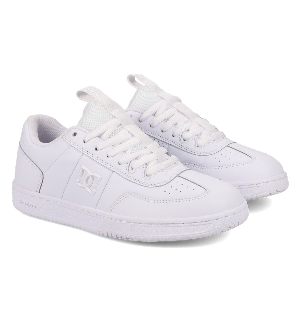 A pair of Women’s Astrix Shoes by DC Shoes in white, featuring laces, a side logo, and textured rubber soles designed for superior board control in street skateboarding, displayed on a white background.
