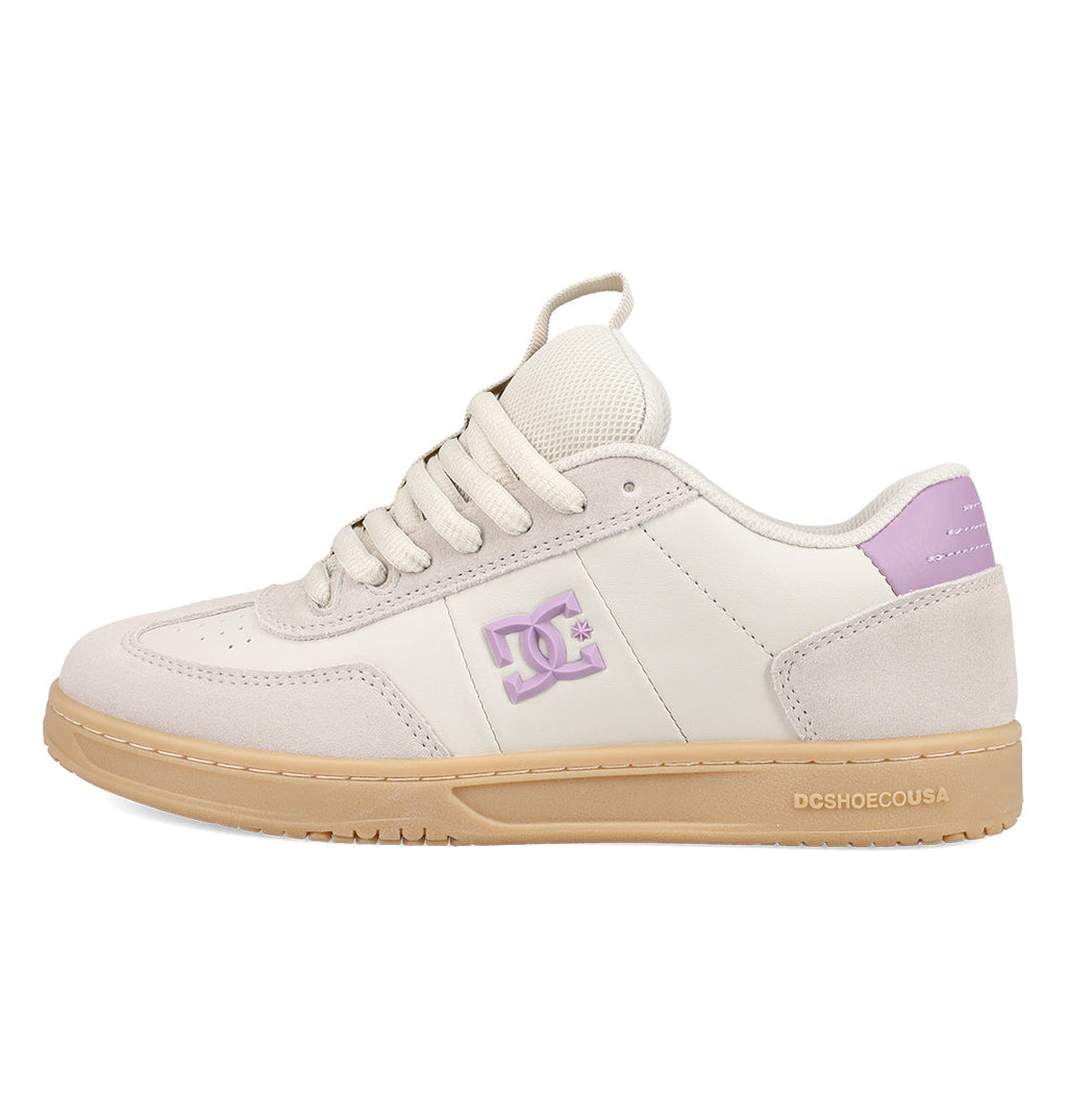 Introducing the Women’s Astrix Shoes from DC Shoes—a skate sneaker in beige and light purple with a gum sole, signature side logo, and perforated toe details. Engineered for superior board control, this style boasts a padded tongue and heel along with “DCSHOECOUSA” text on the sole, making it an ideal choice for street skateboarding.