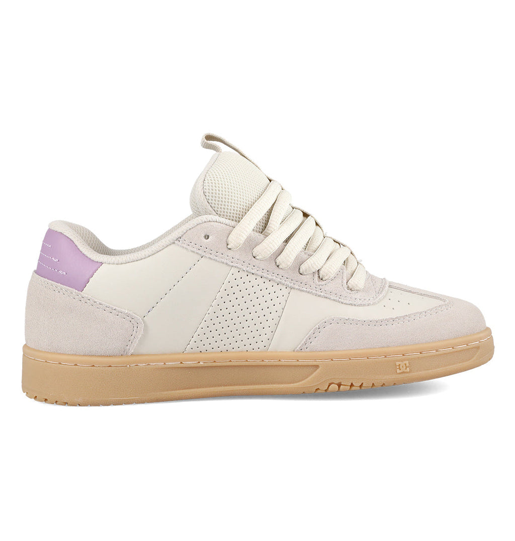 Introducing the Women’s Astrix Shoes by DC Shoes: a beige and off-white skate shoe featuring a light brown sole, perforated side panel for breathability, cream laces, suede accents, and a distinctive lavender detail on the heel. Designed for superior board control, this model is shown from the side on a white background.