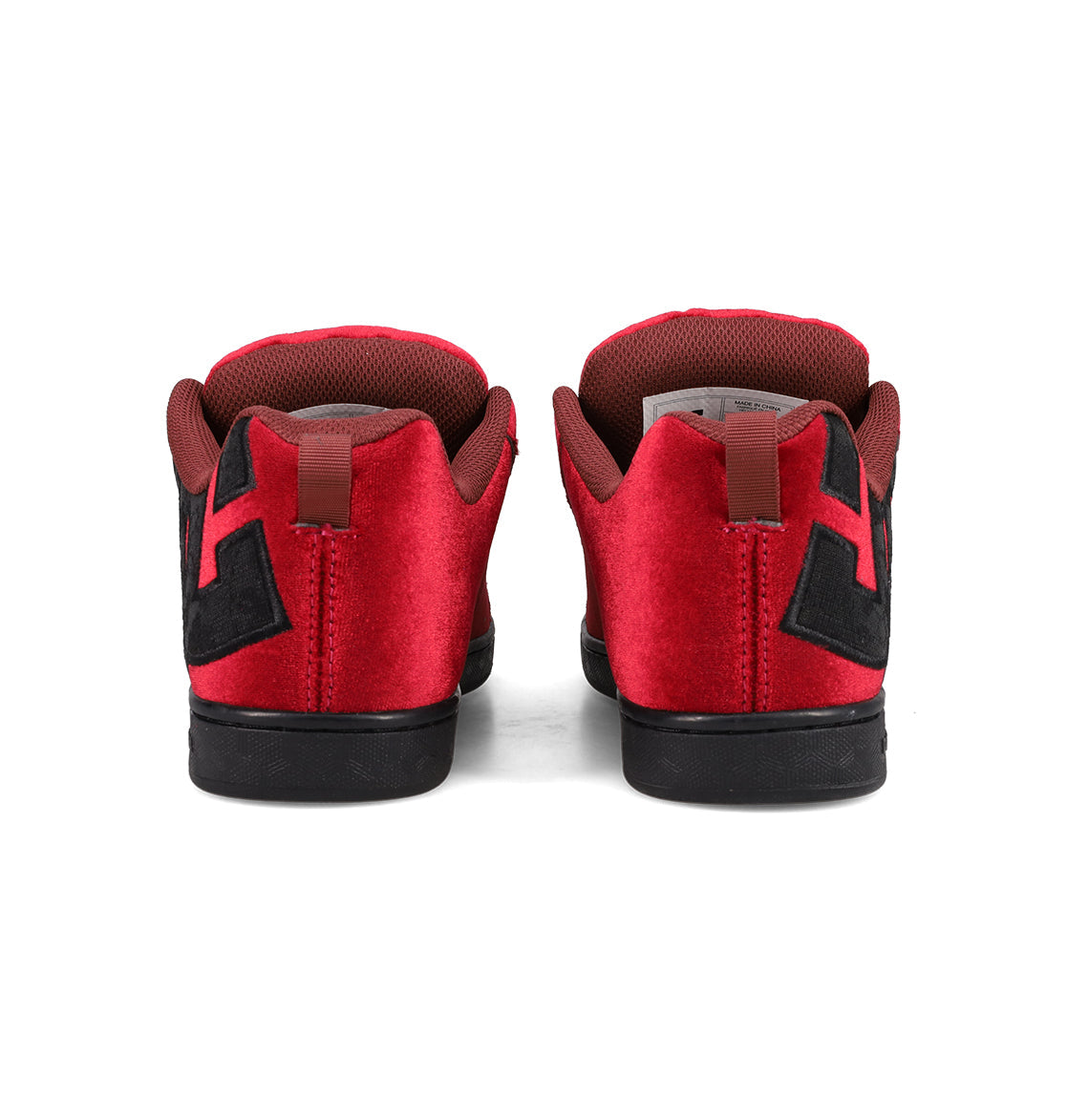 The DC Shoes Women's Court Graffik LE features a puffy silhouette in red velvet with black soles and geometric side designs, shown from the back against a white background.