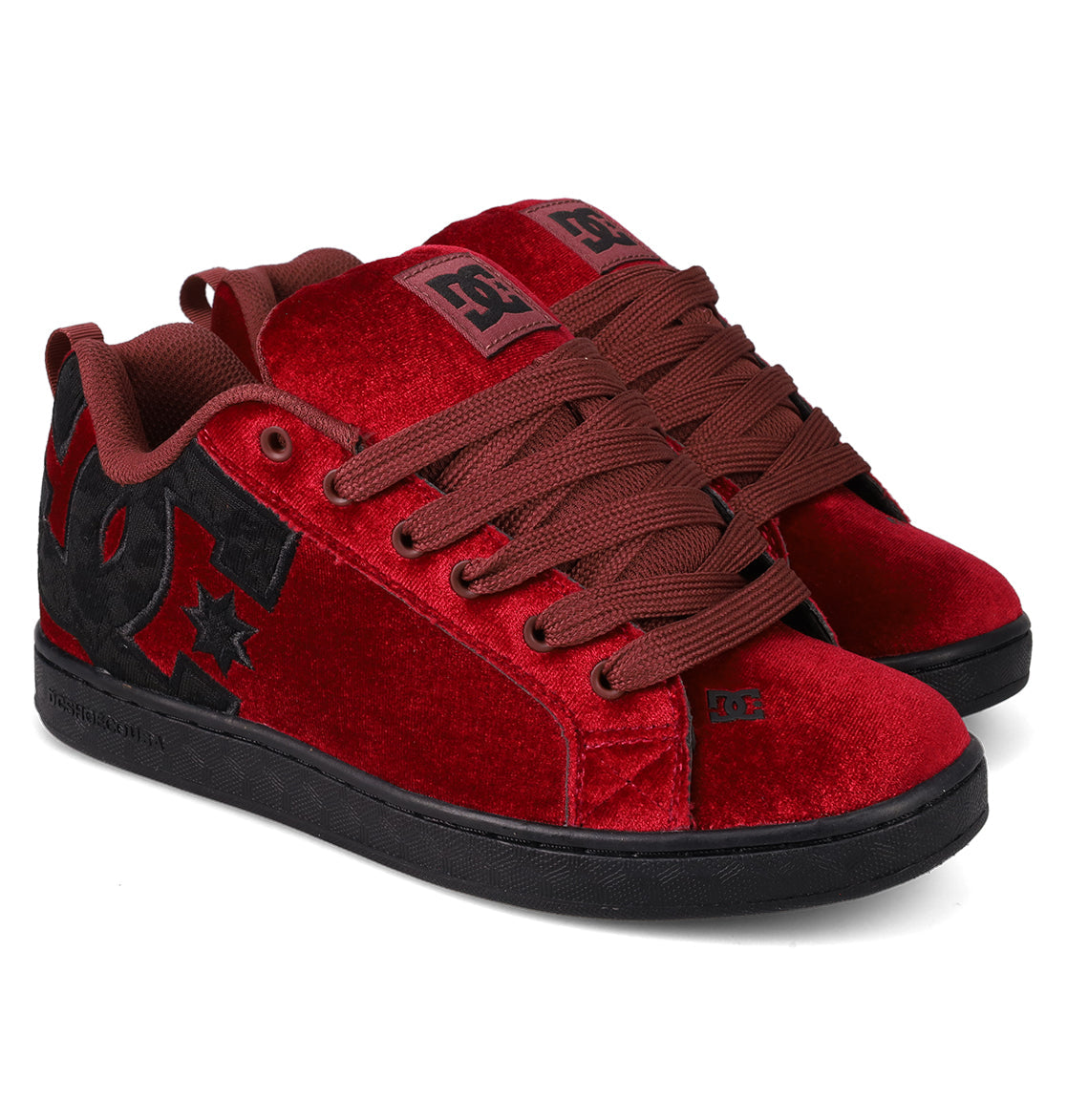 The Women's Court Graffik LE Shoes by DC Shoes feature a red velvet upper, brown laces, black soles, and a large black DC logo with a star on the side. Their puffy silhouette provides style along with comfort and durable premium materials.