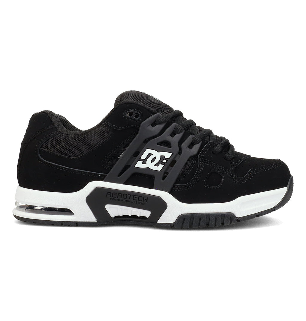 The Men’s AT-2 Shoes by DC Shoes feature a chunky black design with white accents, a gray sole, and “AEROTECH” text on the side. These skate shoes include a visible air cushion in the heel and enhanced AEROTECH ventilation for breathable comfort throughout your ride.